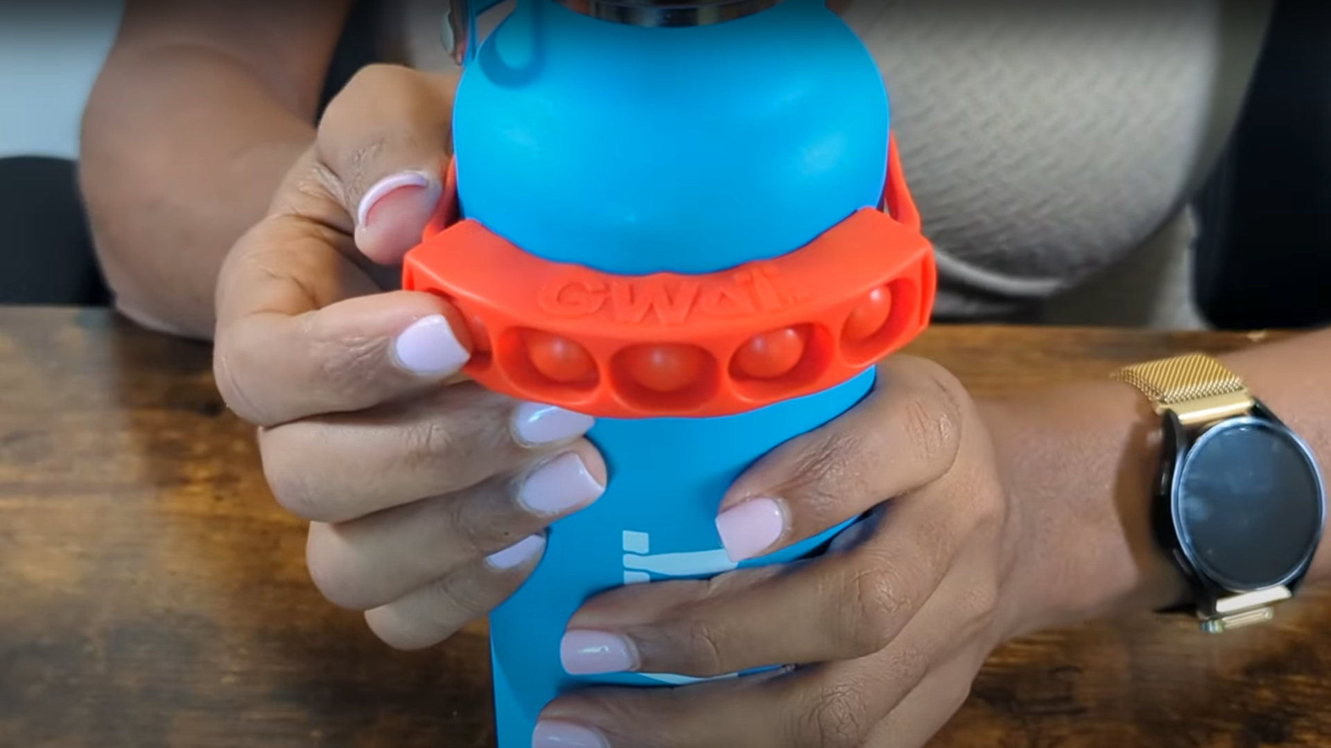 thumbnail video image 2 of GWaT Water Tracker Band for Bottles – Orange Escape – Hydration Reminder Popper for Kids & Adults, 2 of 8