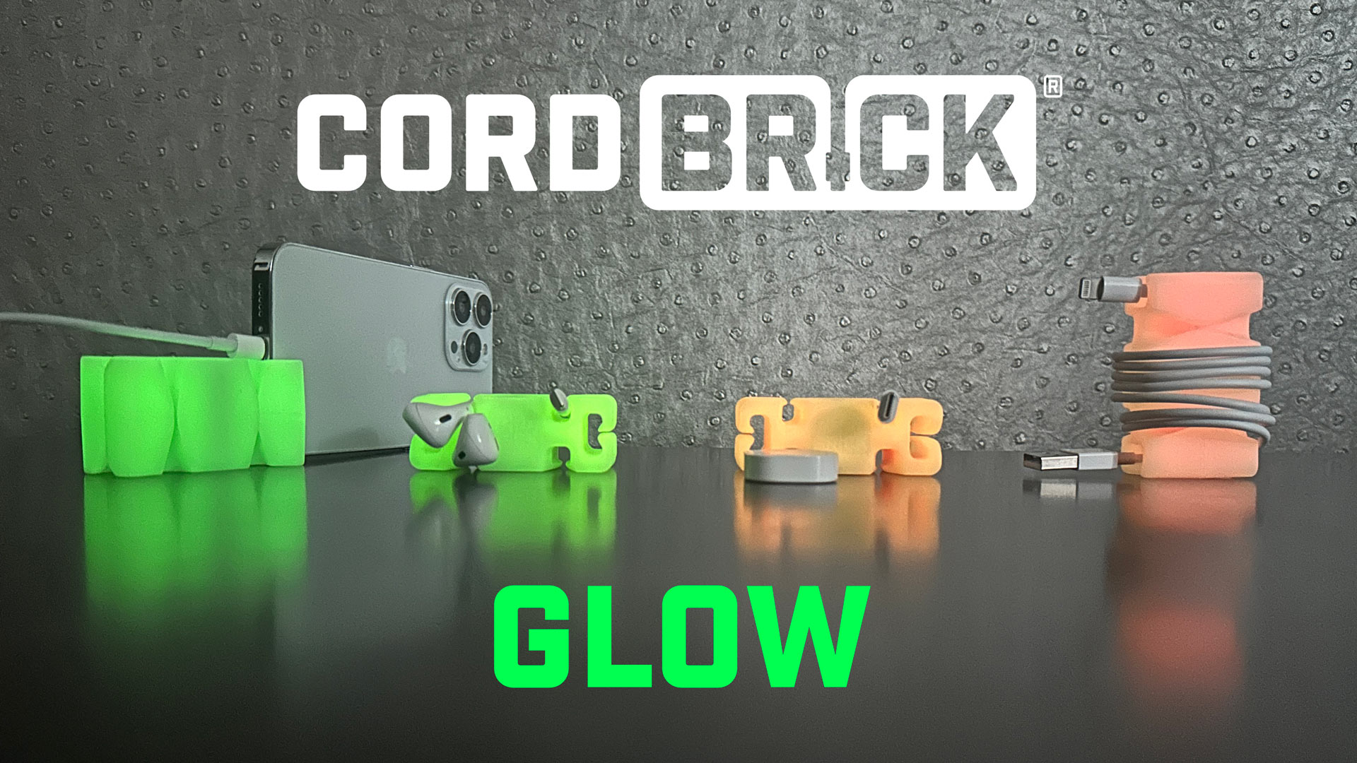 thumbnail video image 2 of CordBrick Glowing Silicone + Steel Weighted Cable Holder for Nighstand, Cord Wrap for Travel, Unique iPhone Accessory. Small Graduation Gift for High Schoolers. Gadget for Teens. Yellow Glow, 2 of 7