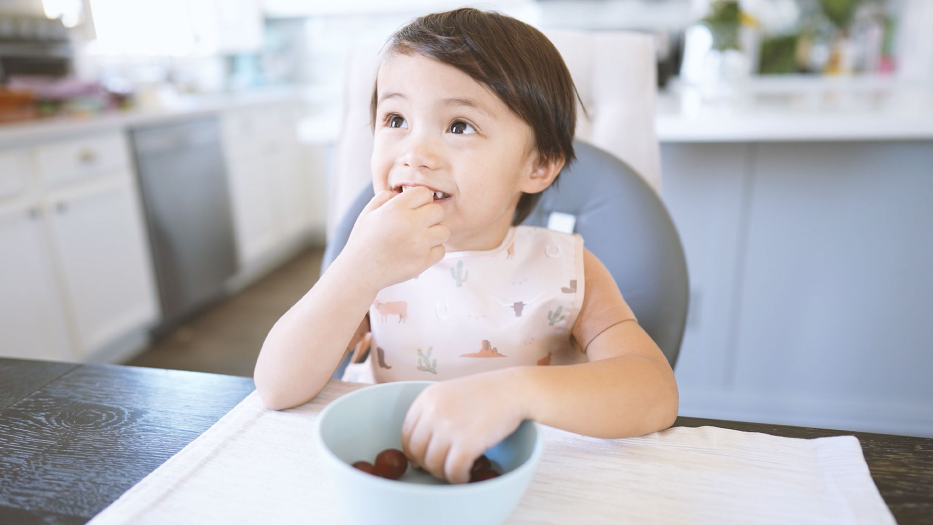 thumbnail video image 2 of Tiny Twinkle Mess-Proof Apron Waterproof Food Bib | Baby & Toddler | PFAS, PVC, BPA and Phthalate Free, 2 of 10