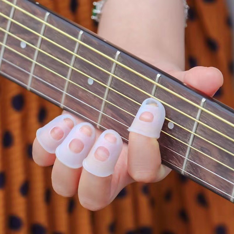 thumbnail video image 2 of Rubber Finger Tips, 4 Pack Silicone Thumb Fingertip Protector Covers Pads Thimble for Guitar Playing Office Counting Sewing, 2 of 5