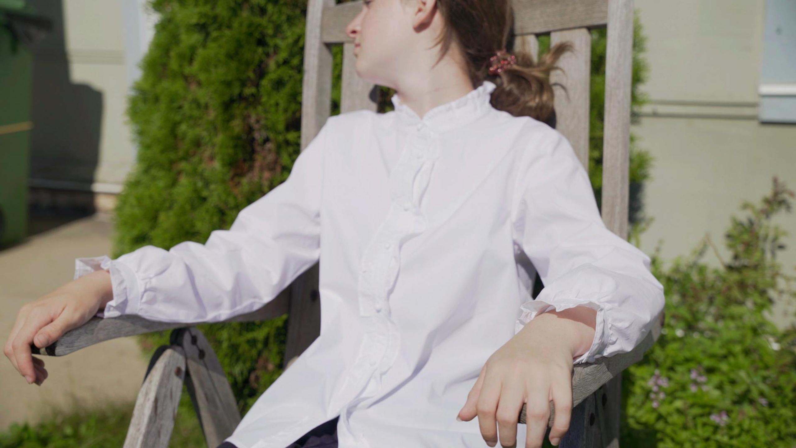 thumbnail video image 2 of SOLOCOTE Girls White Ruffle Long Sleeve Button Down Cotton Blouse, 2 of 6