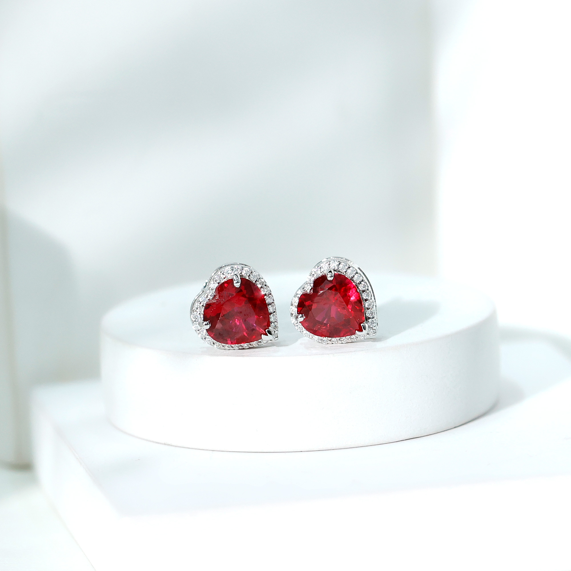 thumbnail video image 2 of Rosec Jewels Heart Shape Created Ruby Stud Earrings with Moissanite Halo (AAAA Grade) - 8 mm, 10K White Gold, 2 of 8