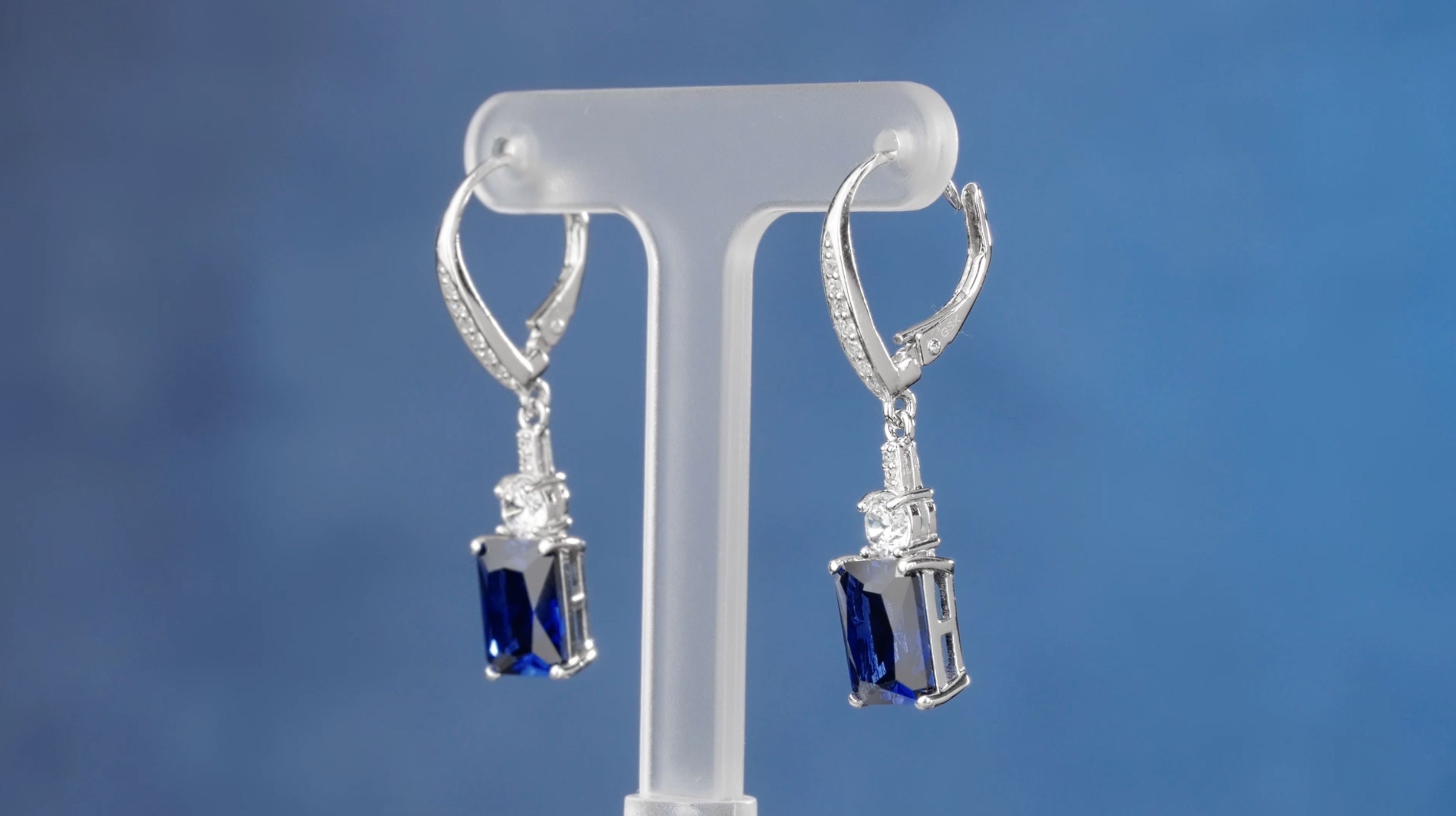 thumbnail video image 2 of Gem Stone King 925 Sterling Silver Red Created Ruby and White Topaz Dangle Earrings for Women (6.26 Cttw, Gemstone July Birthstone, Emerald Cut 9X7MM), 2 of 6