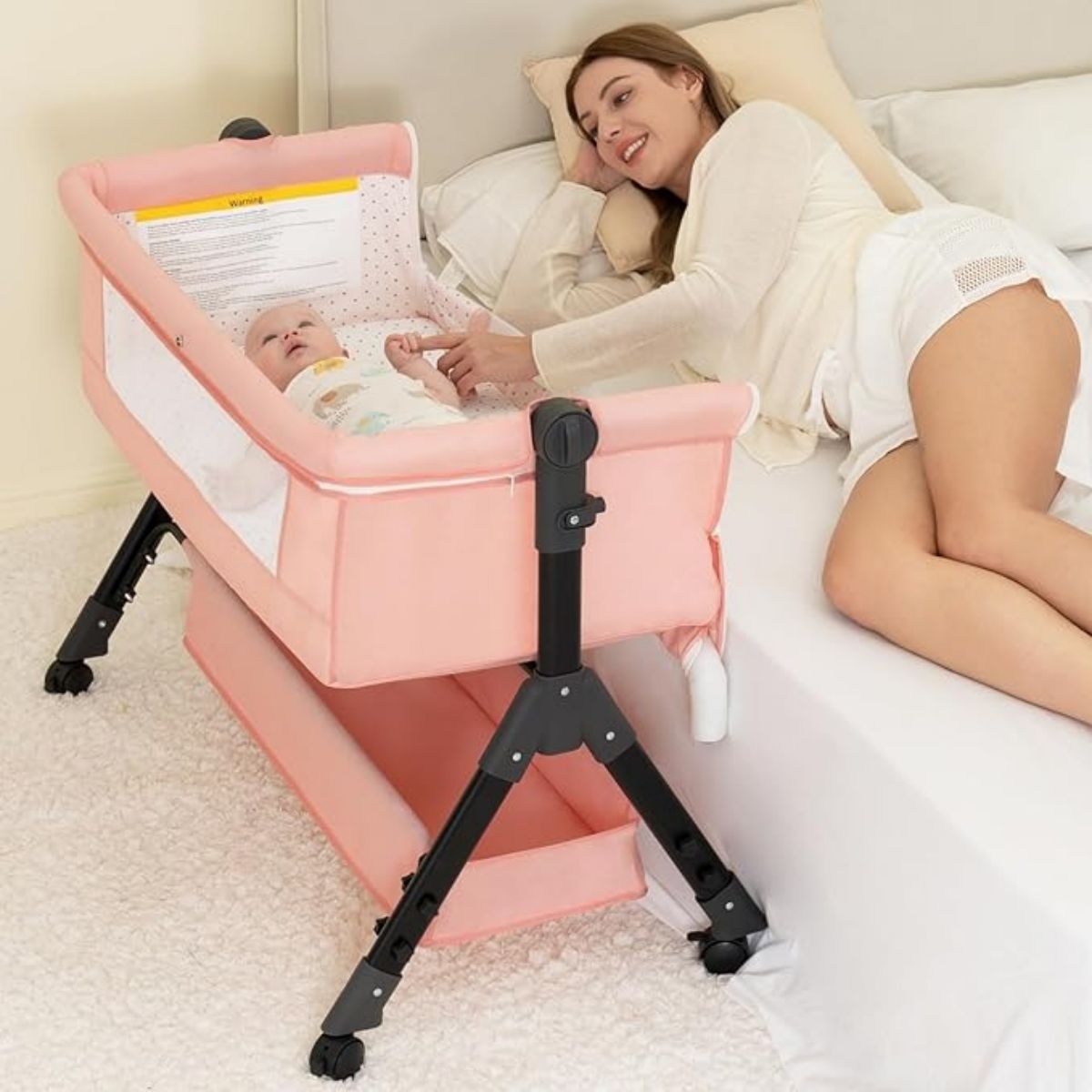 thumbnail video image 2 of kmaier Baby Bassinet Sleeper, Adjustable Bedside Sleeper, Breathable Mesh with Wheels for 0-18 Months-Pink, 2 of 7